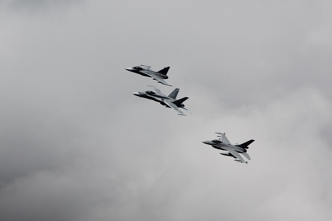 Two fighter jets flying in close formation