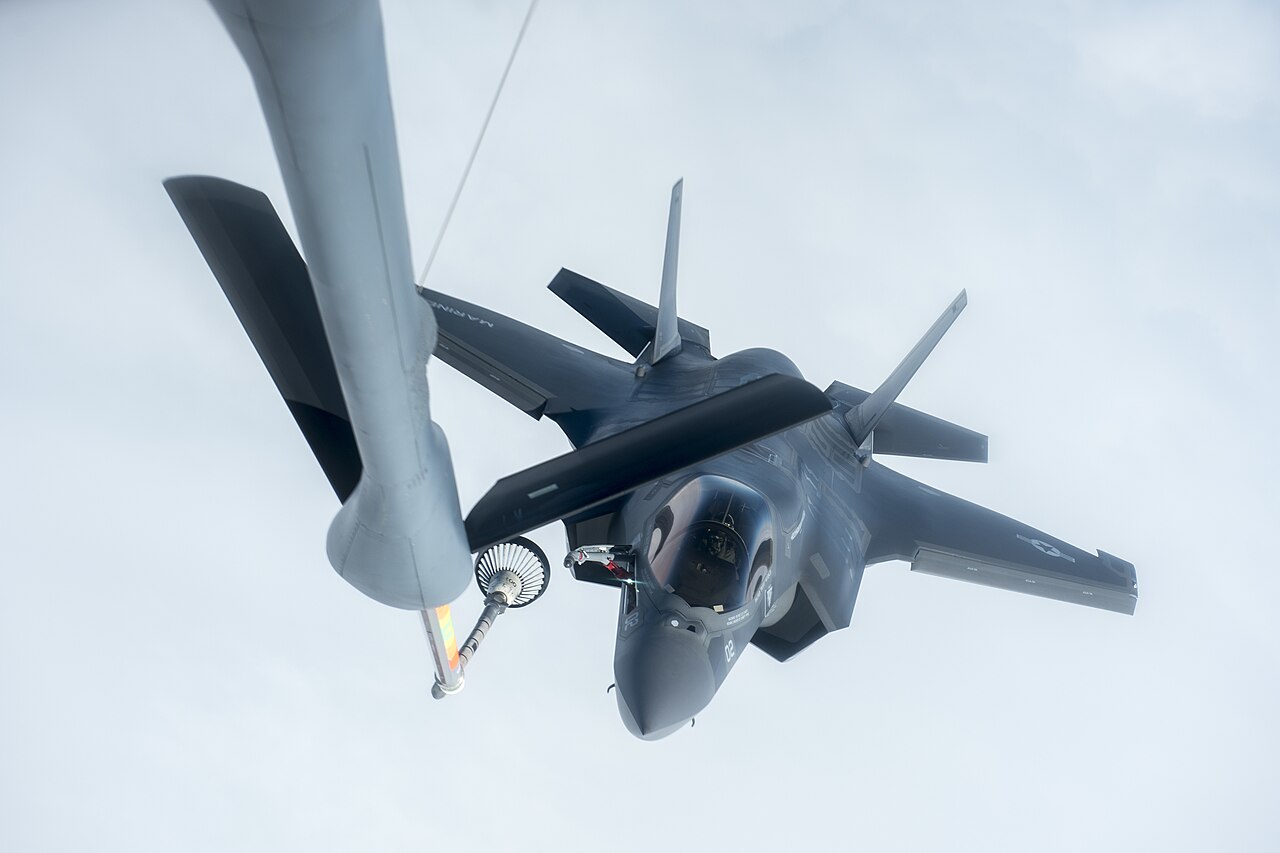 F-35A Lightning II stealth fighter jet being refueled mid-air over the Pacific Ocean