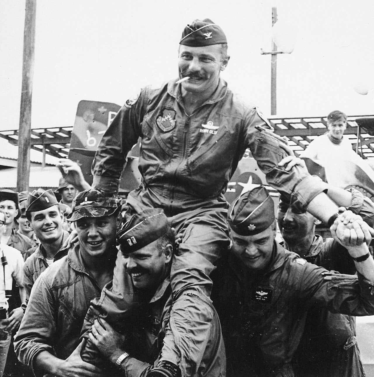 Aviators of the 8th Tactical Fighter Wing carry Col. Robin Olds after his 100th combat mission in 1967