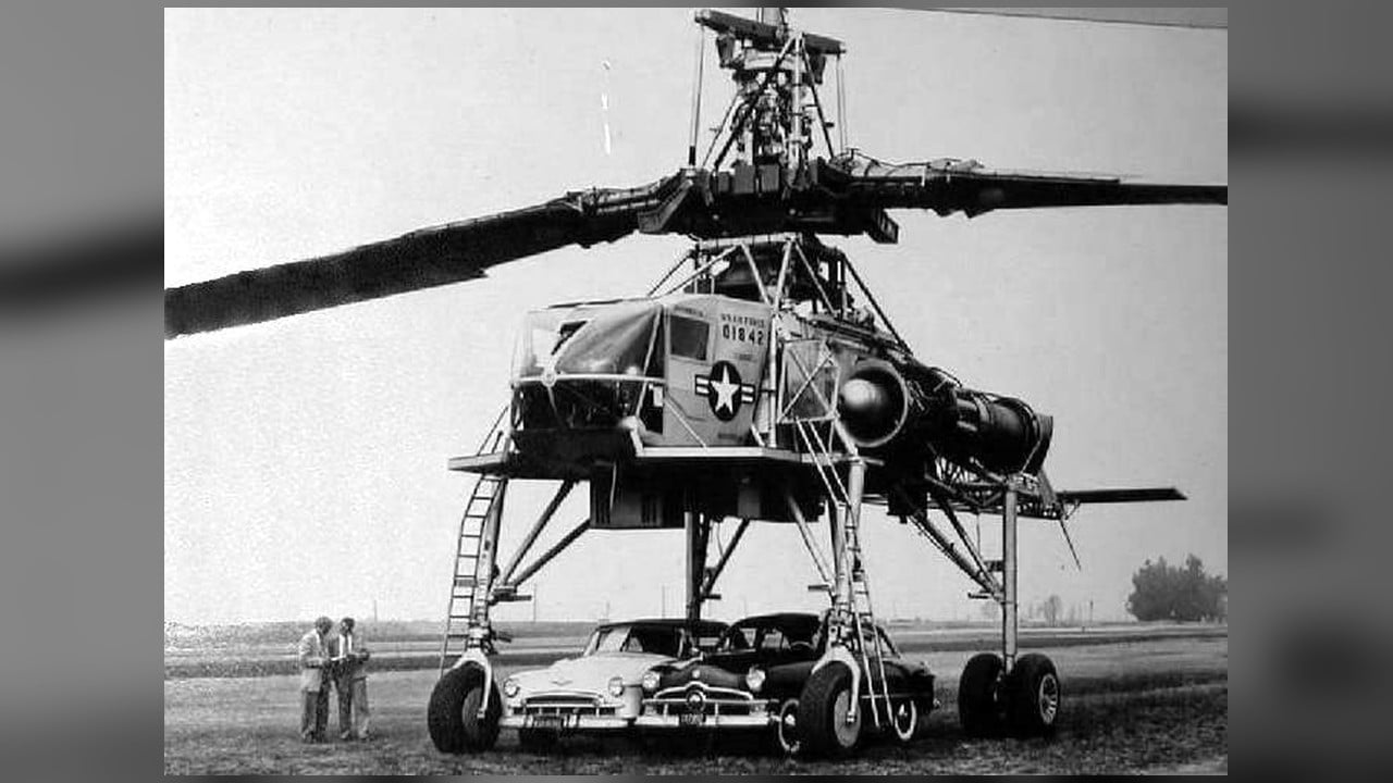 The gigantic Hughes XH-17 helicopter with two cars parked beneath it