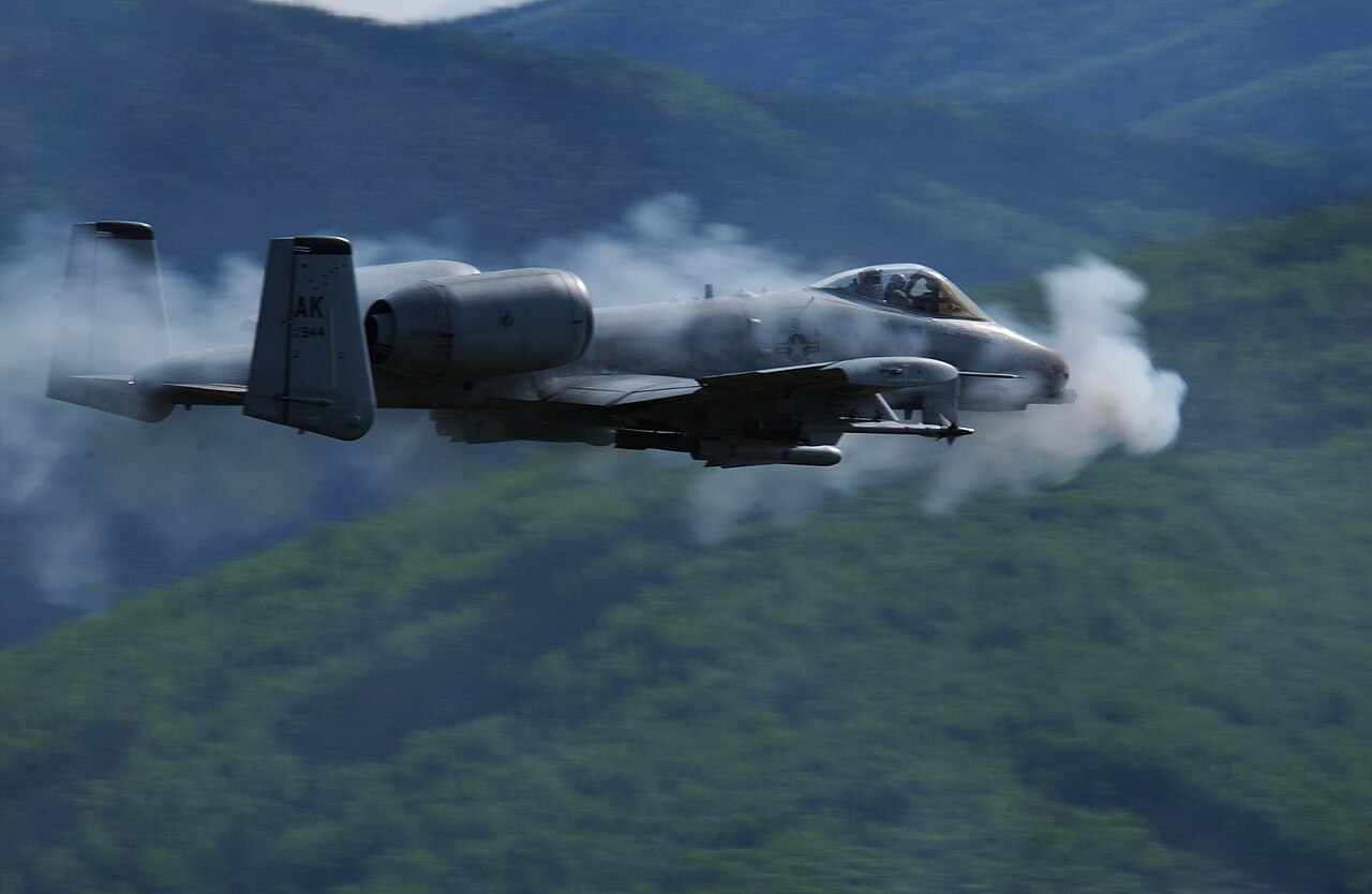 A-10 Thunderbolt II wreathed in gun smoke during a gun run