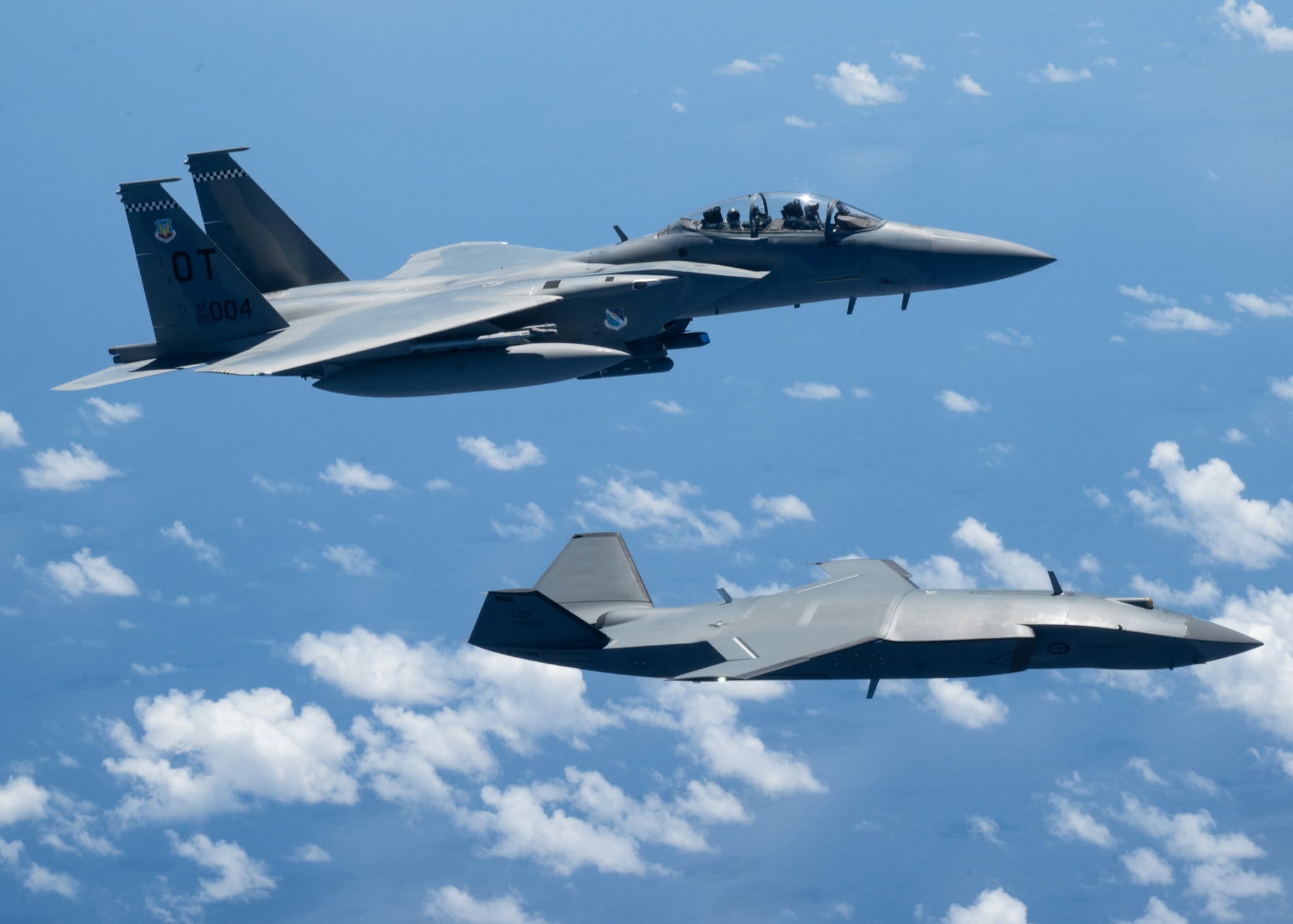 USAF F-15EX Eagle II flying in formation with an MQ-28 Ghost Bat uncrewed loyal-wingman drone