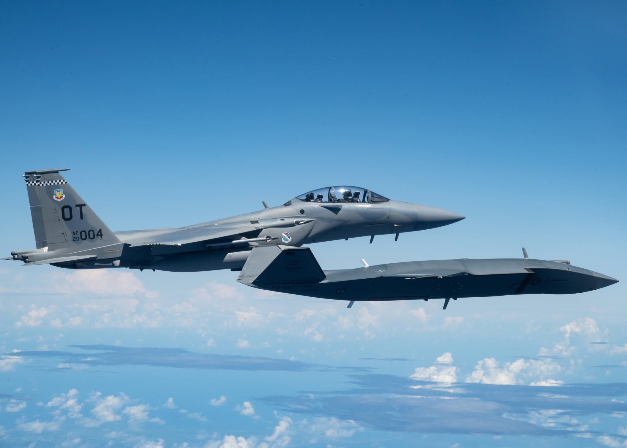 F-15EX and MQ-28 Ghost Bat in formation over the Philippine Sea