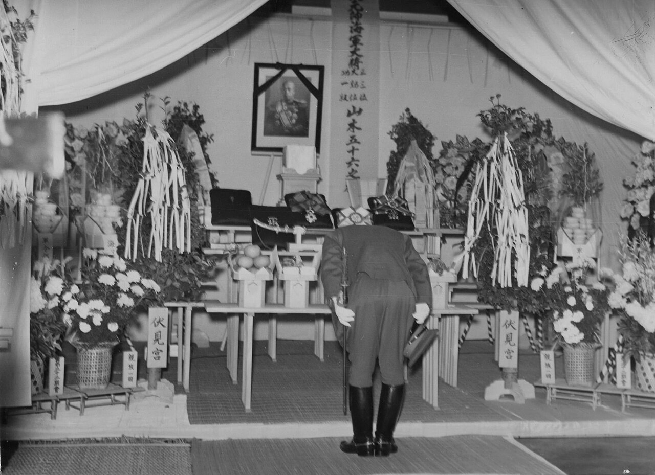 Japanese Prime Minister Hideki Tojo bows before a portrait of Admiral Yamamoto after his death