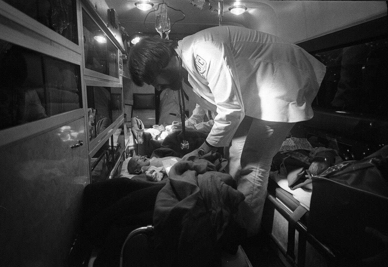 Medical staff examining Vietnamese children after an Operation Babylift flight arrival, 1975
