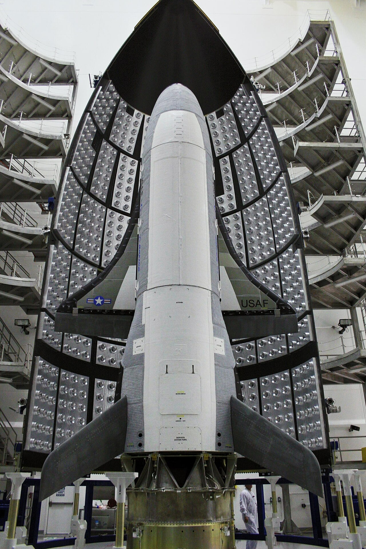 The Boeing X-37B being encapsulated inside its launch fairing