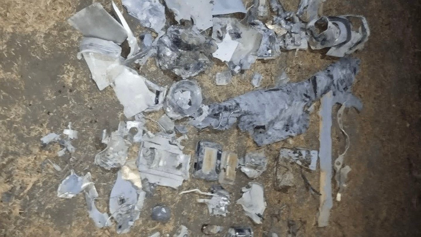 Fragments of a Raytheon ADM-160 Miniature Air-Launched Decoy laid out on the ground in Iran