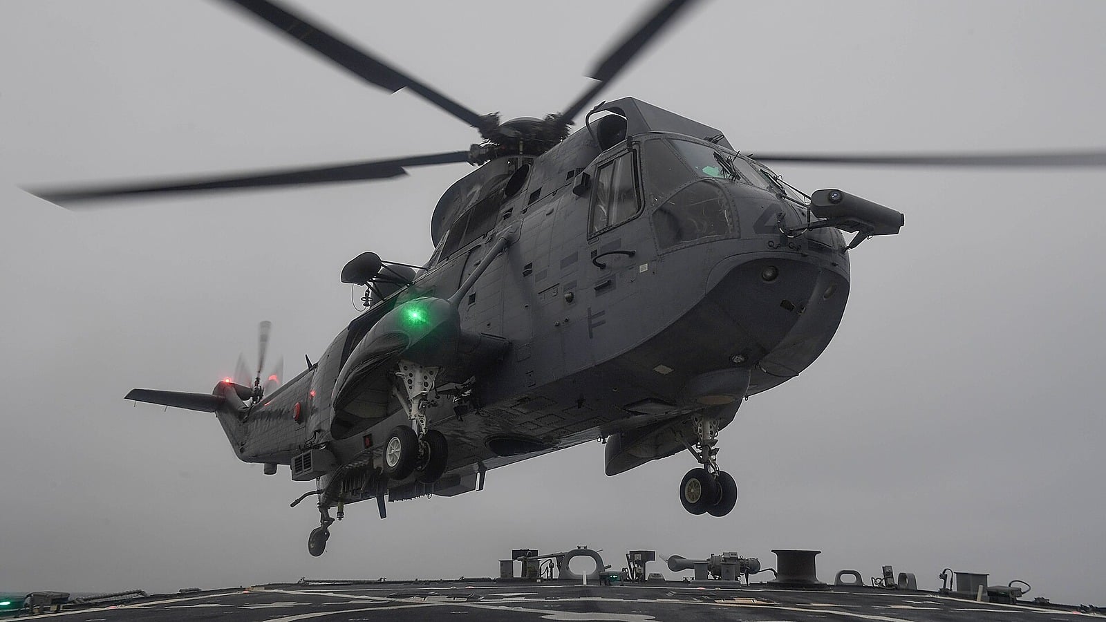 Royal Canadian Navy CH-124 Sea King hovering over a destroyer flight deck A Royal Canadian Navy CH-124 Sea King hovers a few feet above the flight deck of a guided-missile destroyer in grey weather