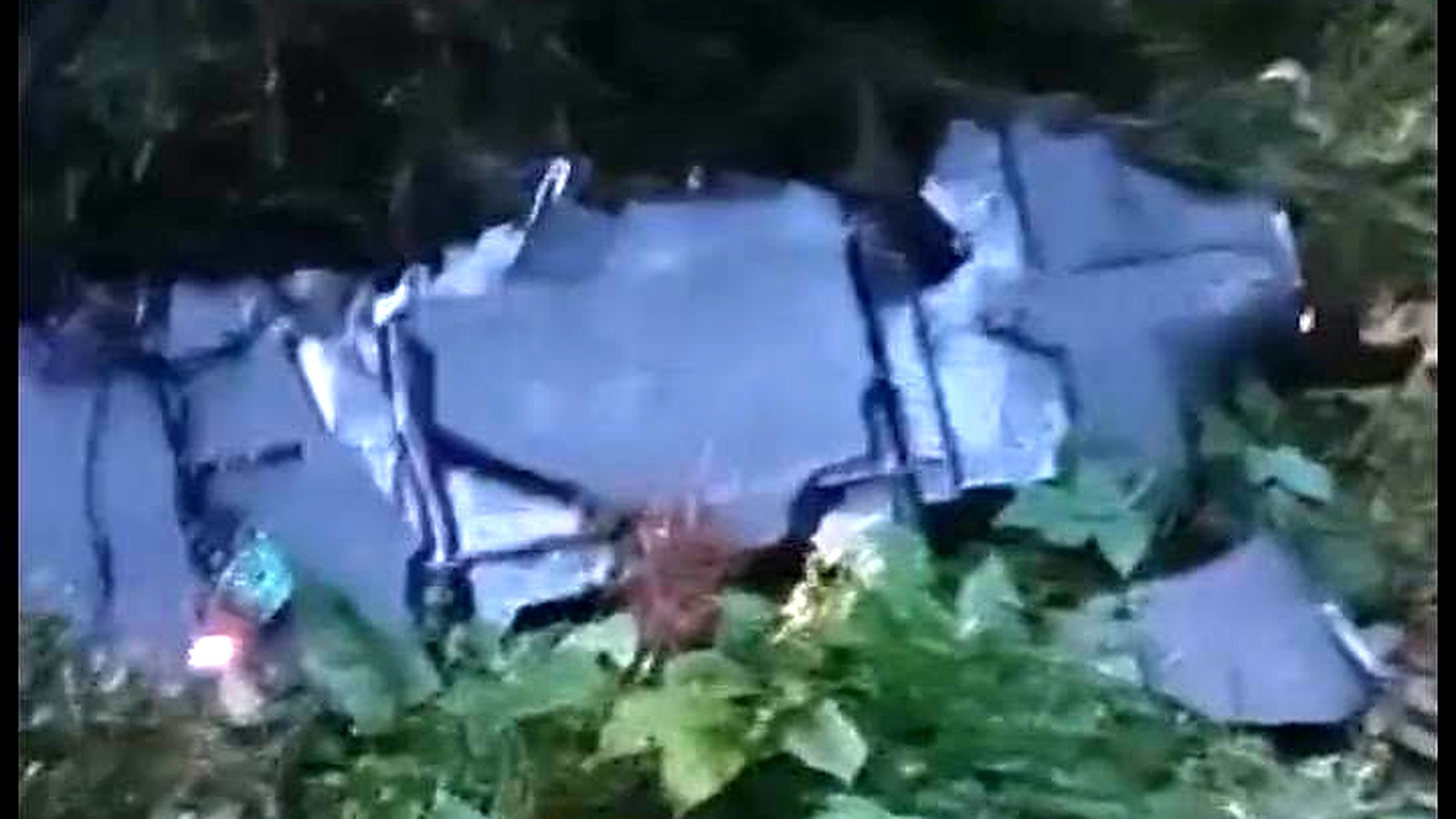 Grey wreckage of a crashed drone lying among conifers near Solca in Suceava county, Romania