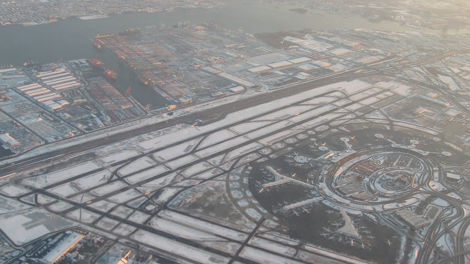 Aerial view of Newark Liberty International Airport showing runways, terminals and the adjacent rail corridor