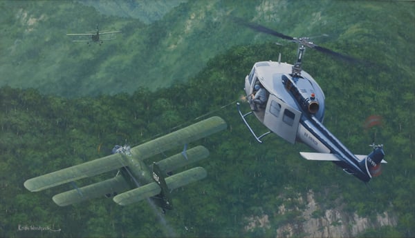 Painting of an Air America Huey engaging An-2 biplanes over Lima Site 85