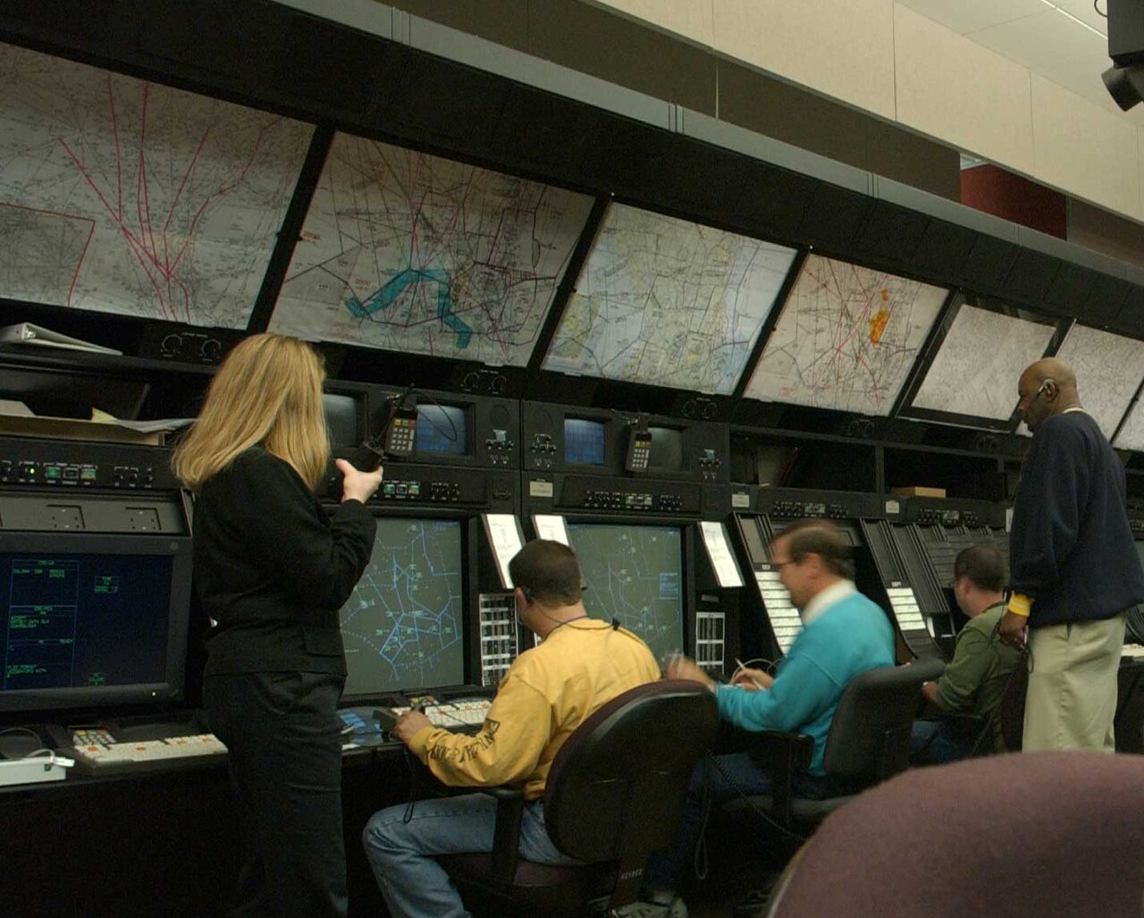 Air traffic controllers working positions in a control facility