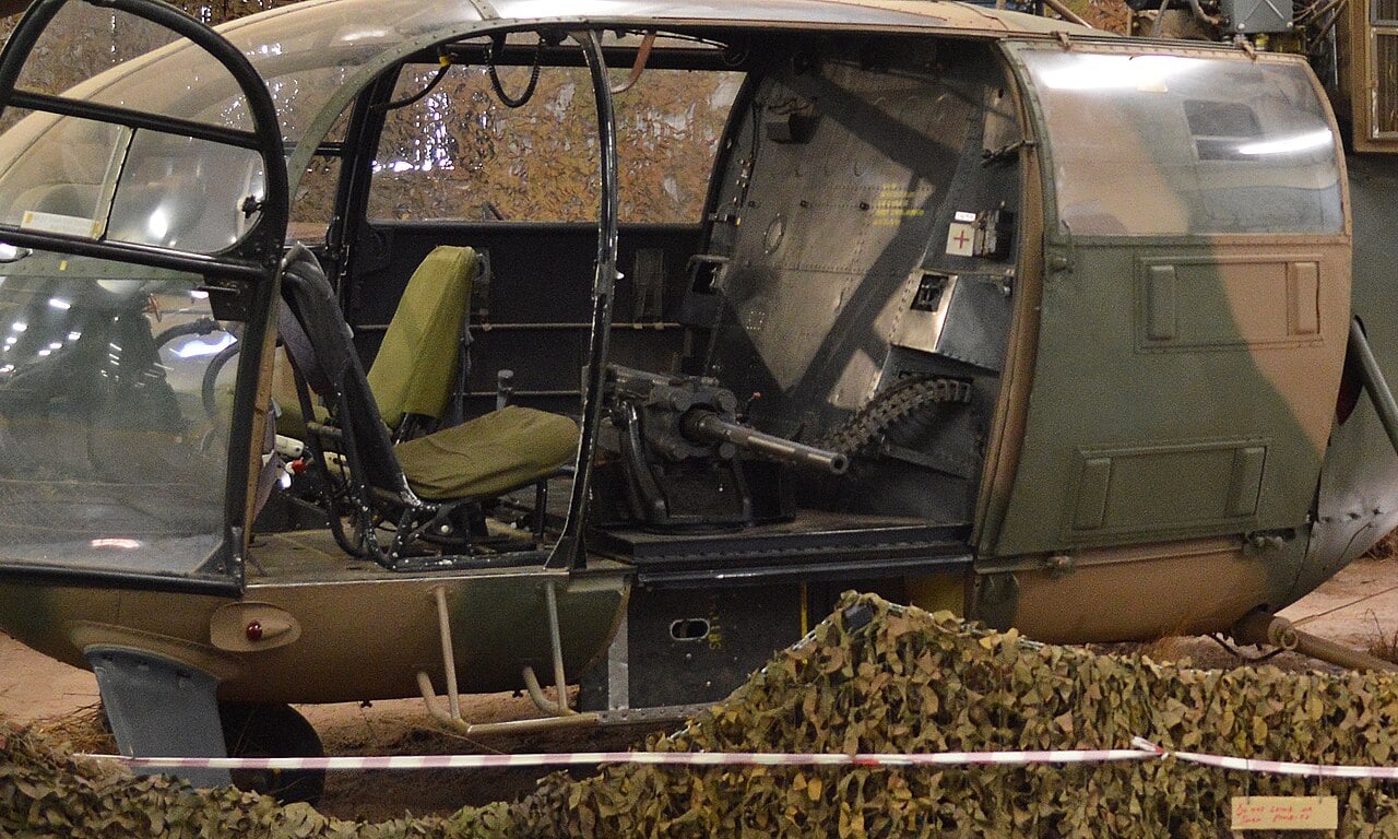 The cabin of an Alouette III helicopter fitted with an MG 151 20 mm cannon firing to port, in K-Car gunship configuration