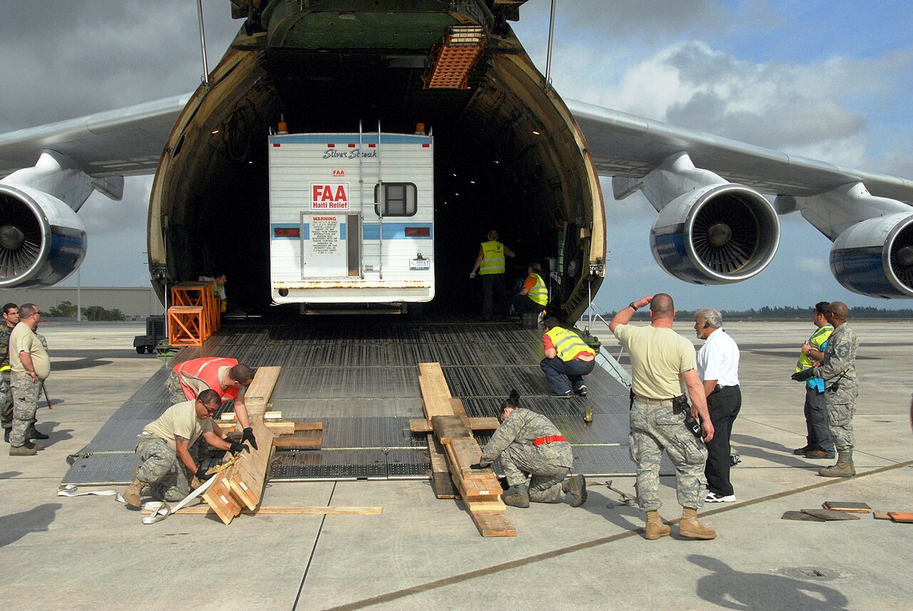 A trailer being loaded through the nose door and ramp of an Antonov An-124