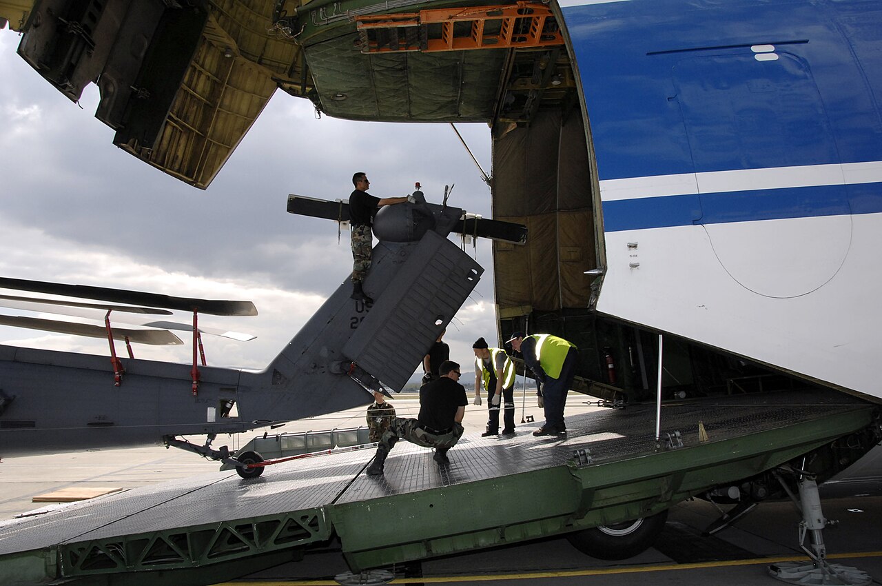 A helicopter being loaded through the nose door of an An-124 outsize cargo freighter