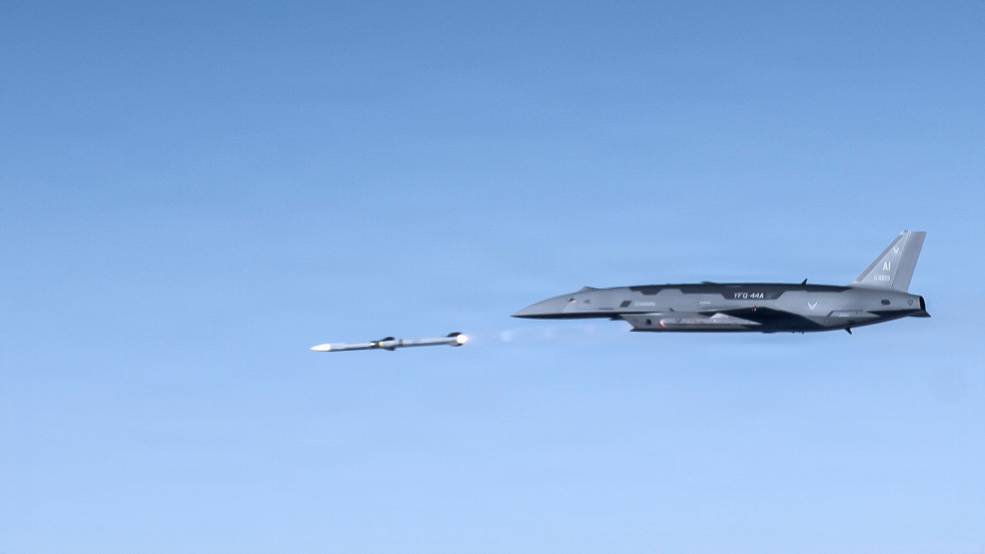 Anduril YFQ-44A Fury collaborative combat aircraft firing an AIM-120 An Anduril YFQ-44A Fury collaborative combat aircraft firing an AIM-120 missile over the Mojave Desert