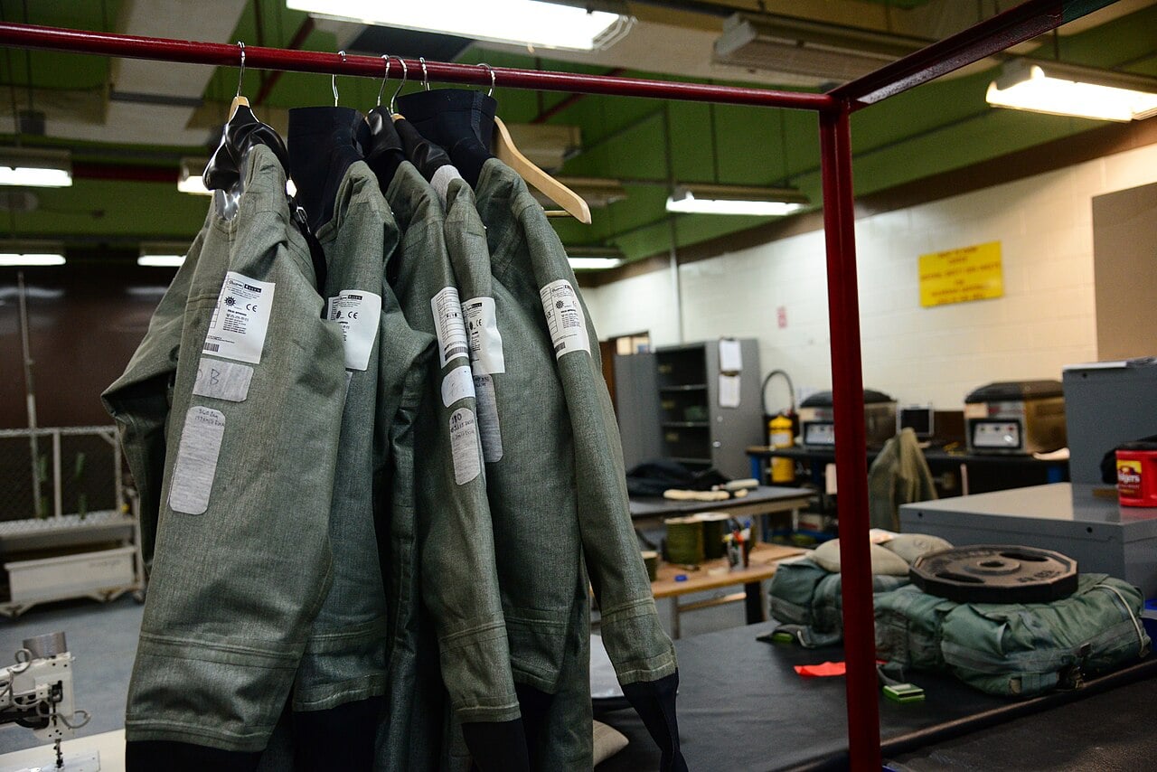 Anti-exposure flight suits hanging in a US Air Force aircrew flight equipment shop