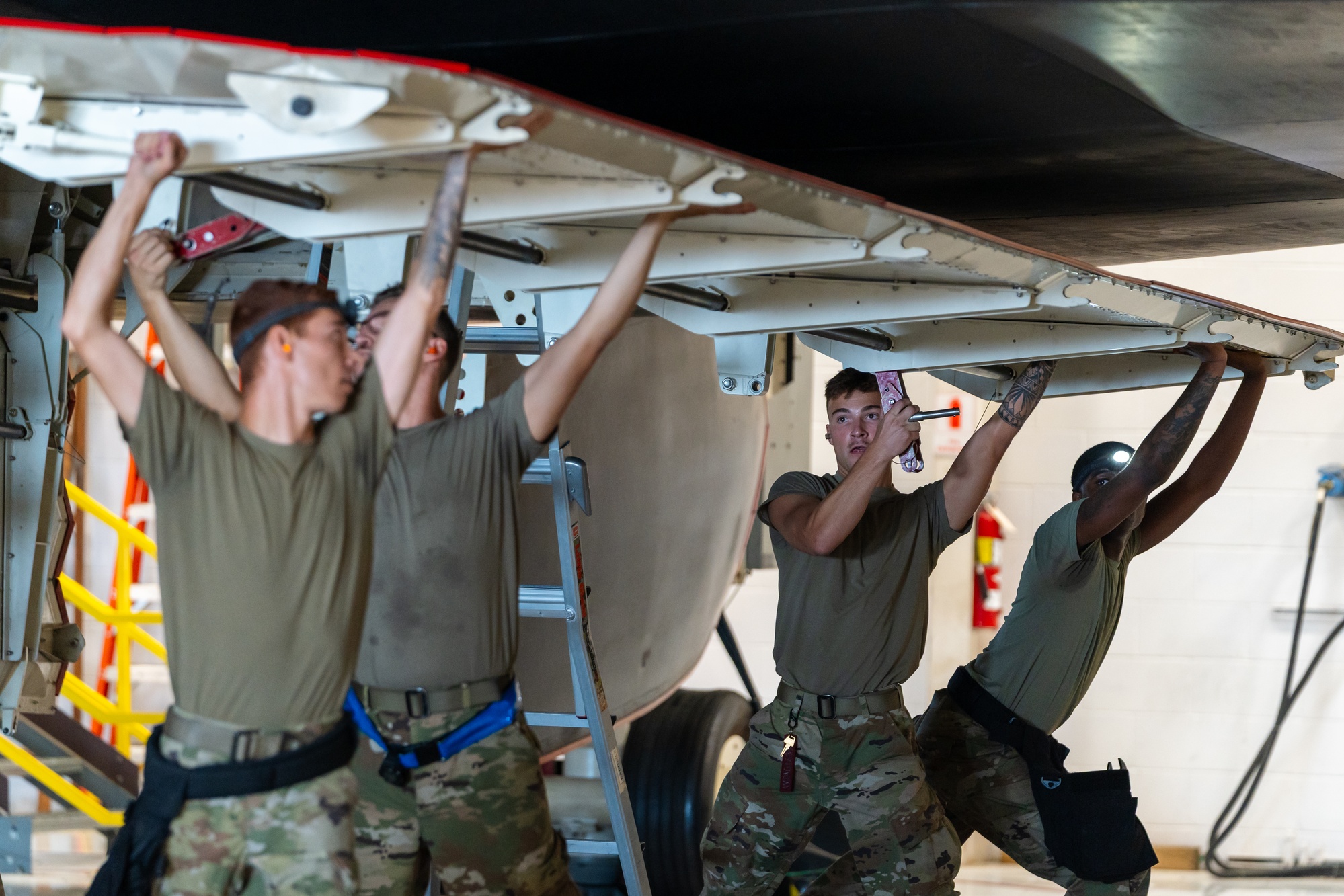 Airmen secure the bomb bay door of a B-2 Spirit weapons trainer at Whiteman Air Force Base