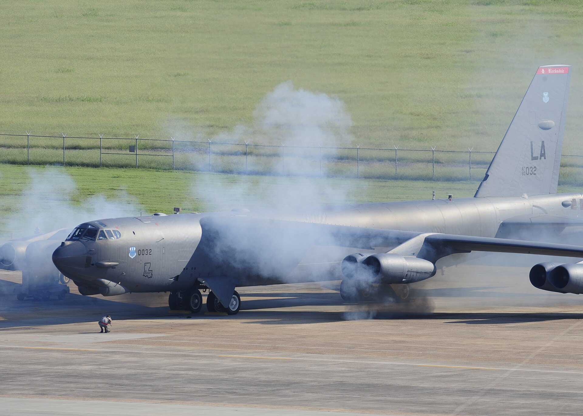 A B-52H Stratofortress wreathed in smoke while starting its engines with pyrotechnic cartridges