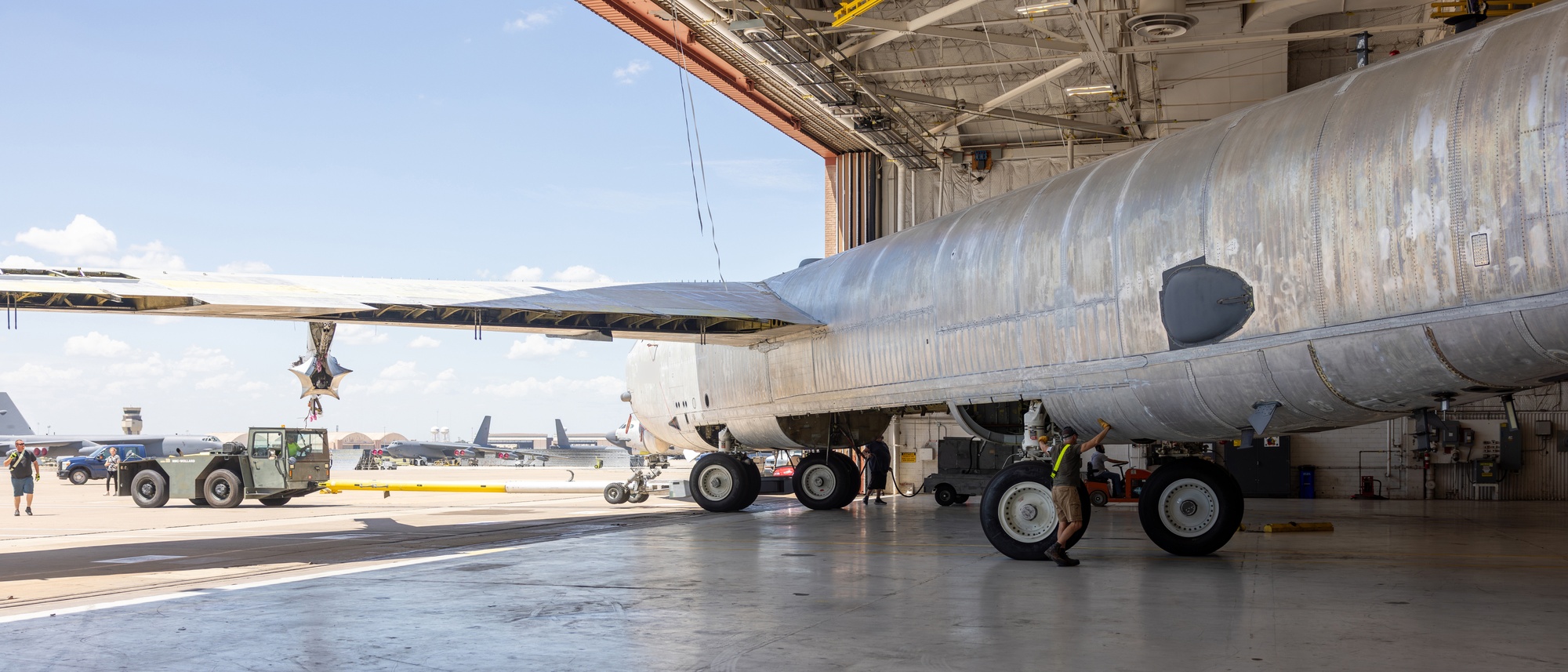 A B-52H towed diagonally into a hangar at Tinker Air Force Base