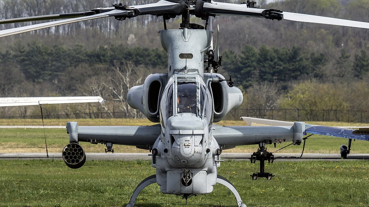 A Bell AH-1Z Viper attack helicopter seen head-on with its chin turret and stub wings