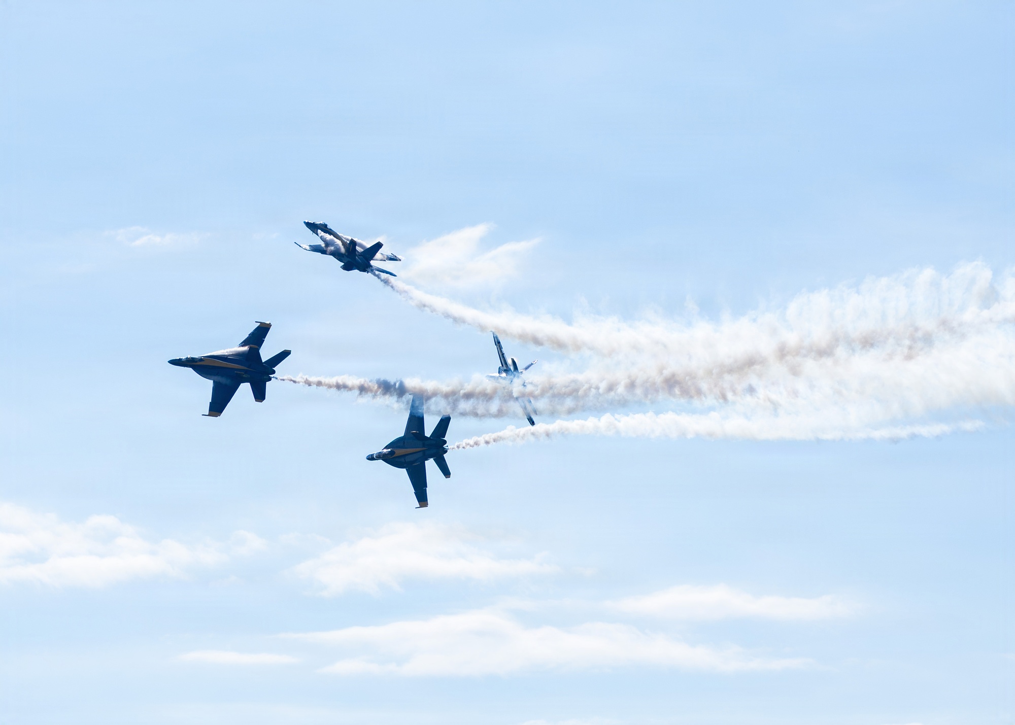 Four US Navy Blue Angels F/A-18 Super Hornets breaking out of formation trailing smoke at the 2026 NAS Oceana Air Show