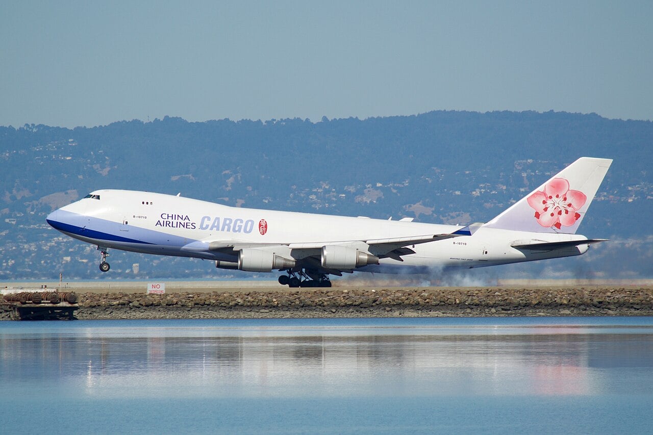 Un Boeing 747-400 atterrit à San Francisco, dégageant de la fumée de pneus.