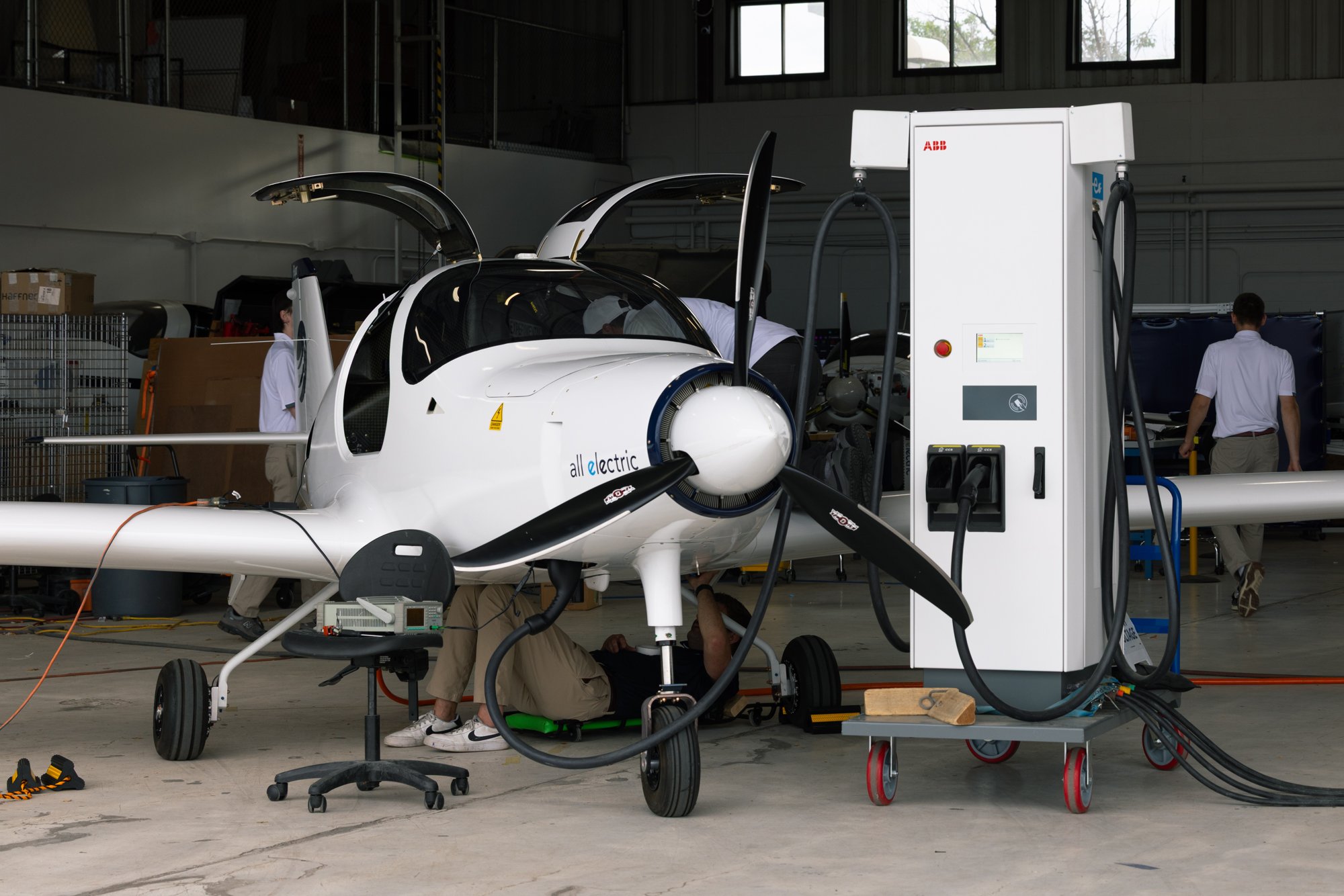 Bye Aerospace eFlyer 2 connected to a charger in the company hangar