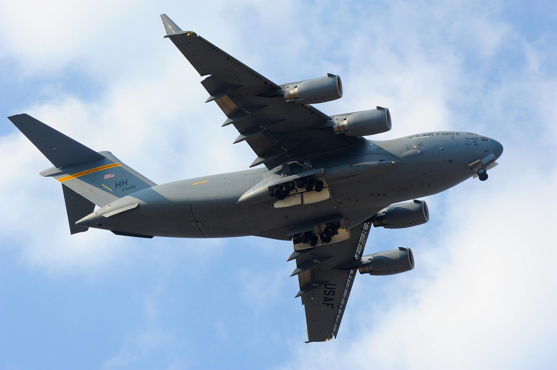 A C-17 Globemaster III with landing gear deployed