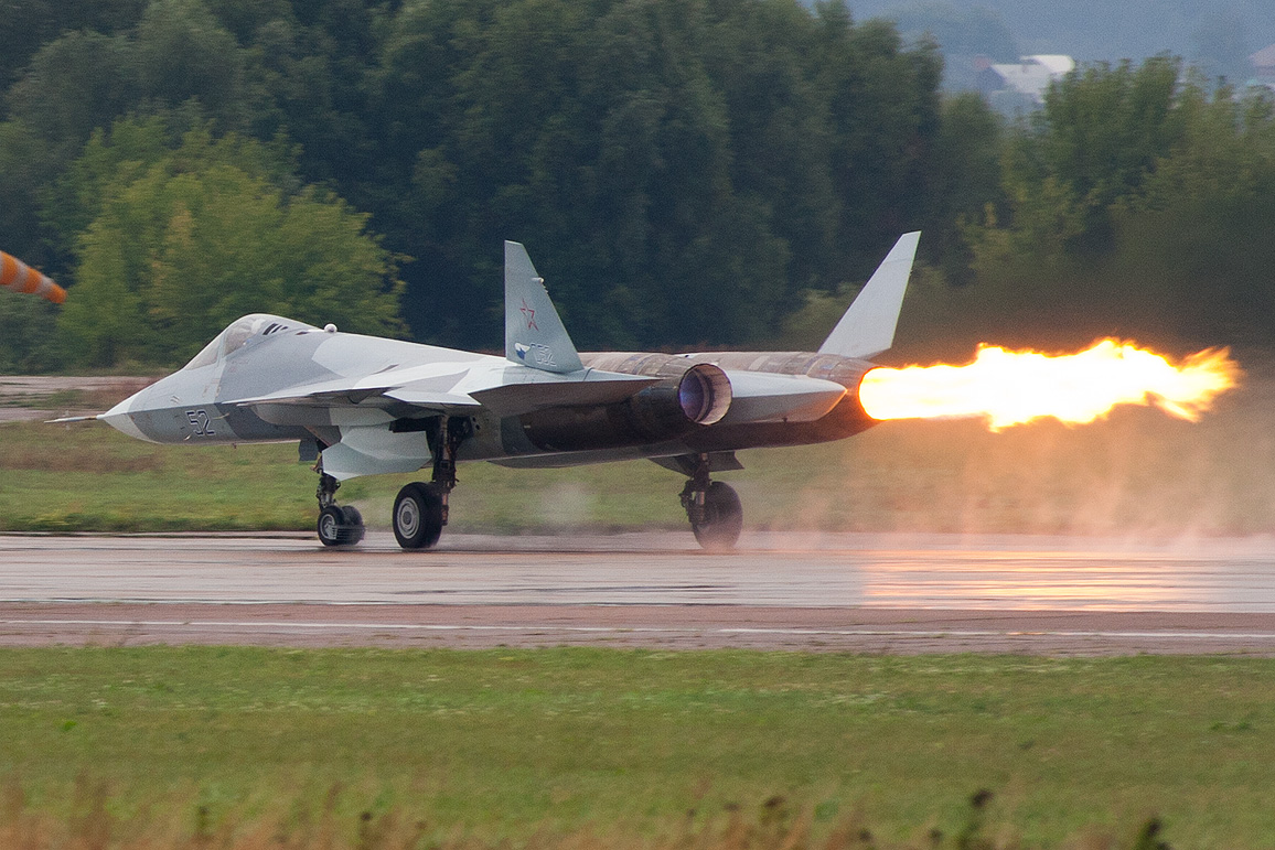 A visible compressor stall flame erupting from a Sukhoi T-50 during a display at MAKS 2011