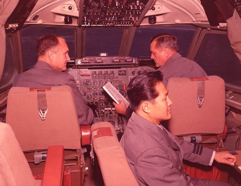 Three uniformed airline pilots on the flight deck of a Convair 880 jetliner in the early 1960s