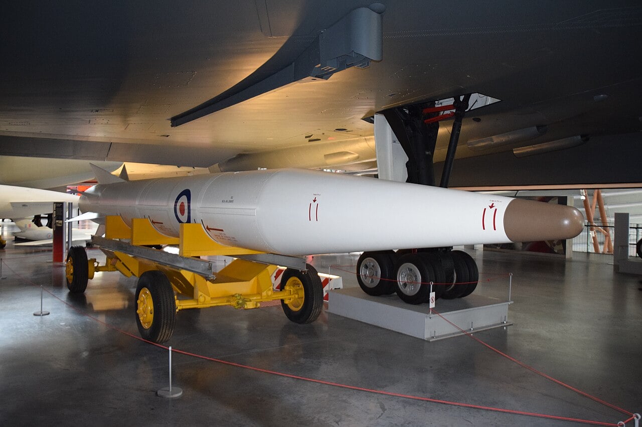 A Douglas GAM-87 Skybolt air-launched ballistic missile in RAF roundels beneath a V-bomber wing