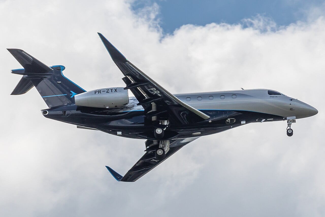 An Embraer Praetor 600 business jet on approach with the landing gear extended