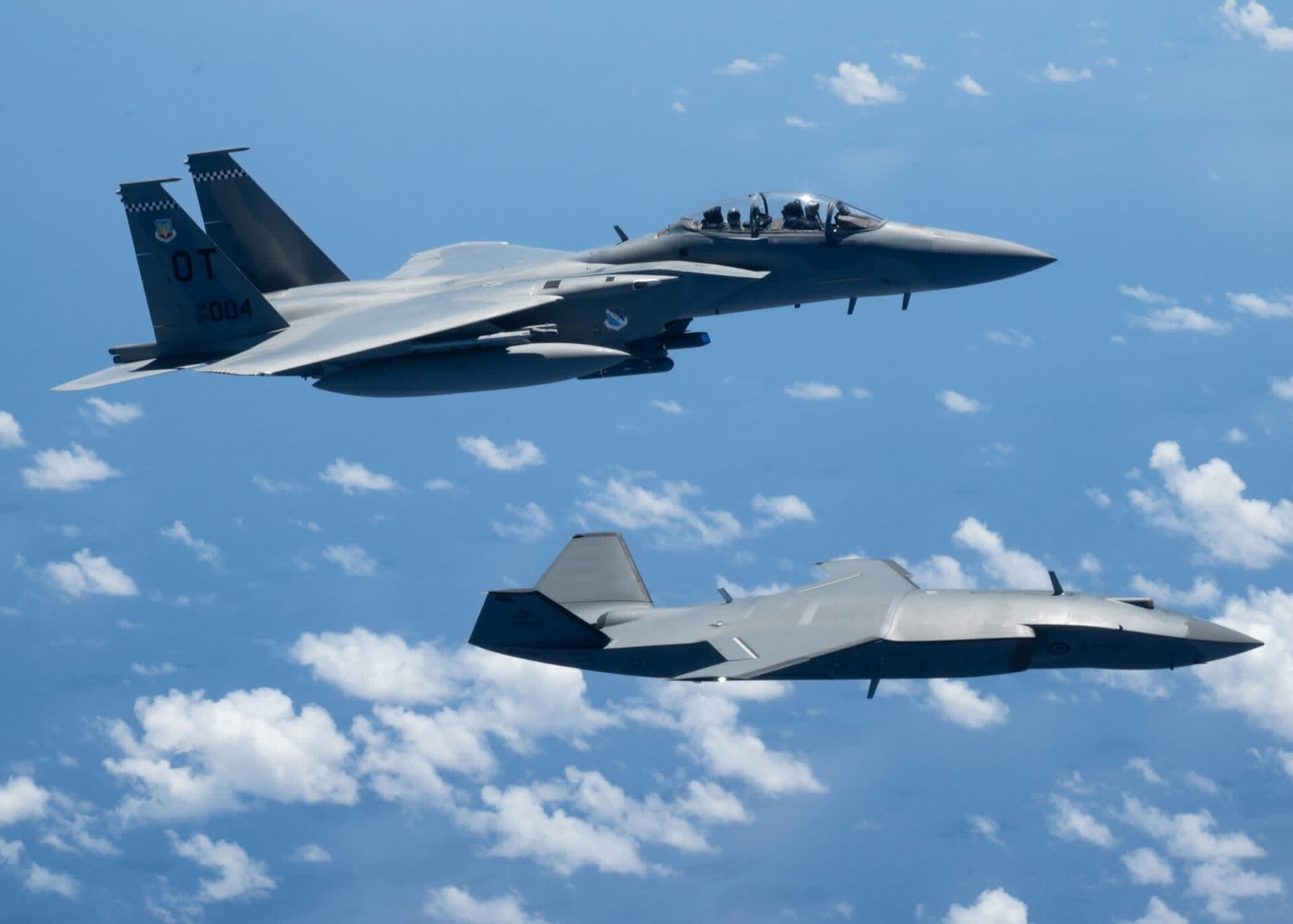F-15EX Eagle II flying with an MQ-28 Ghost Bat
