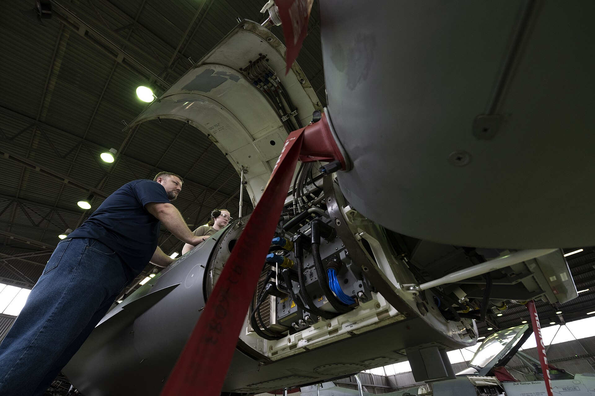 Technicians installing an AESA radar in the nose of an F-16 at Spangdahlem Air Base