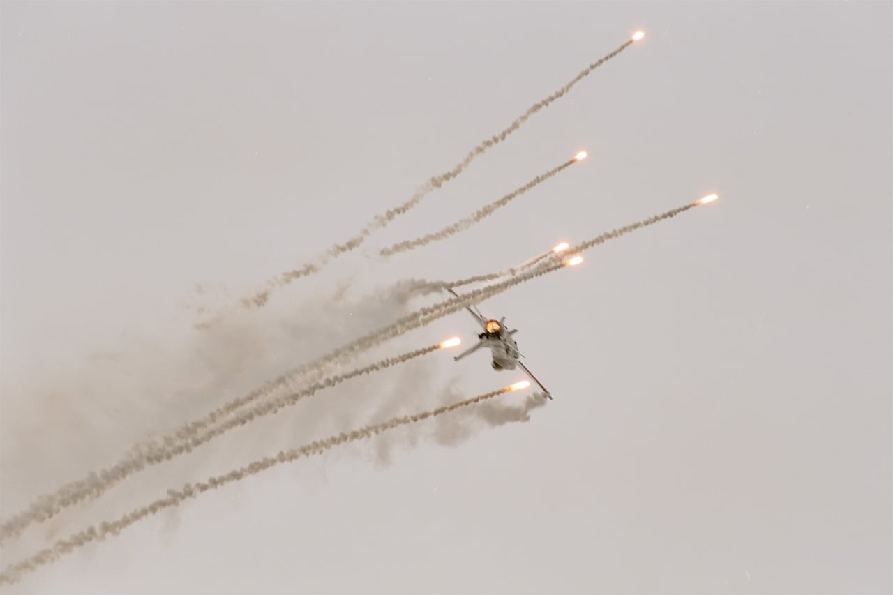 An F-16 dispensing infrared decoy flares