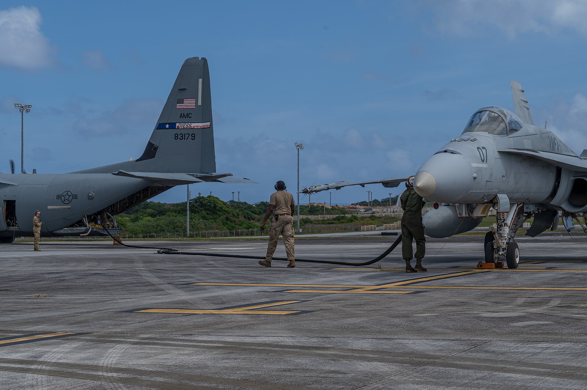 F/A-18 taking fuel from a C-130 on the ground during Cope North 2022