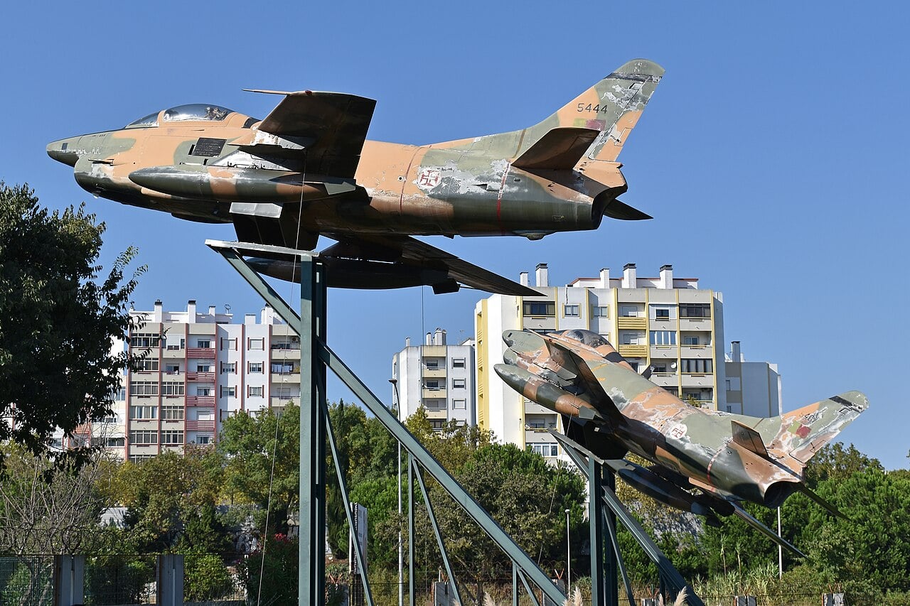 Two Portuguese Air Force Fiat G.91 R3s in African camouflage mounted on pylons in Lisbon