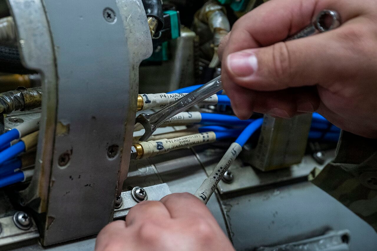 Air Force avionics technicians working on fighter aircraft systems