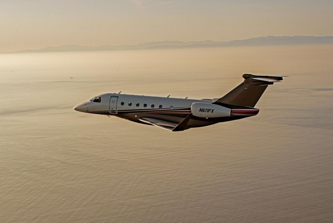 Flexjet Embraer Praetor 600E in flight A Flexjet Embraer Praetor 600E super-midsize business jet in flight at sunset