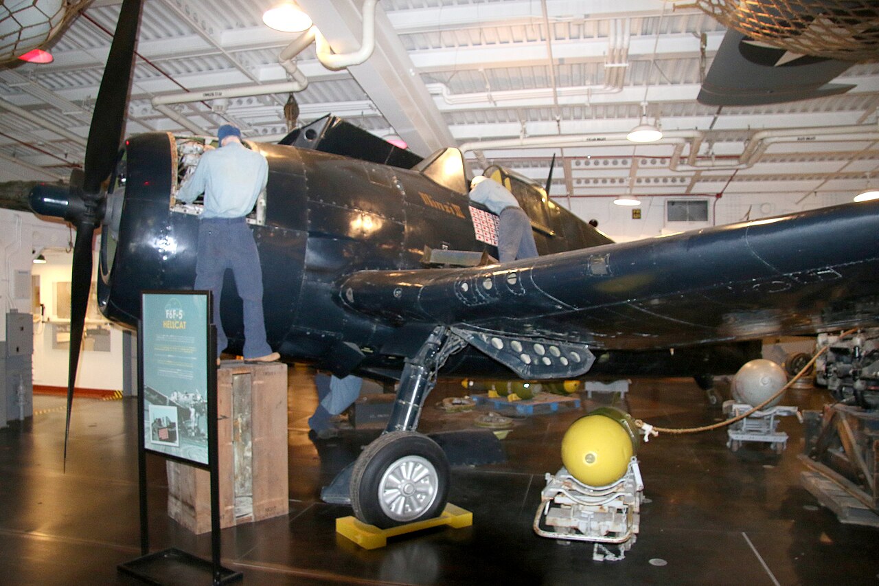 A flying Grumman F6F-5 Hellcat painted in the dark blue markings of Minsi III