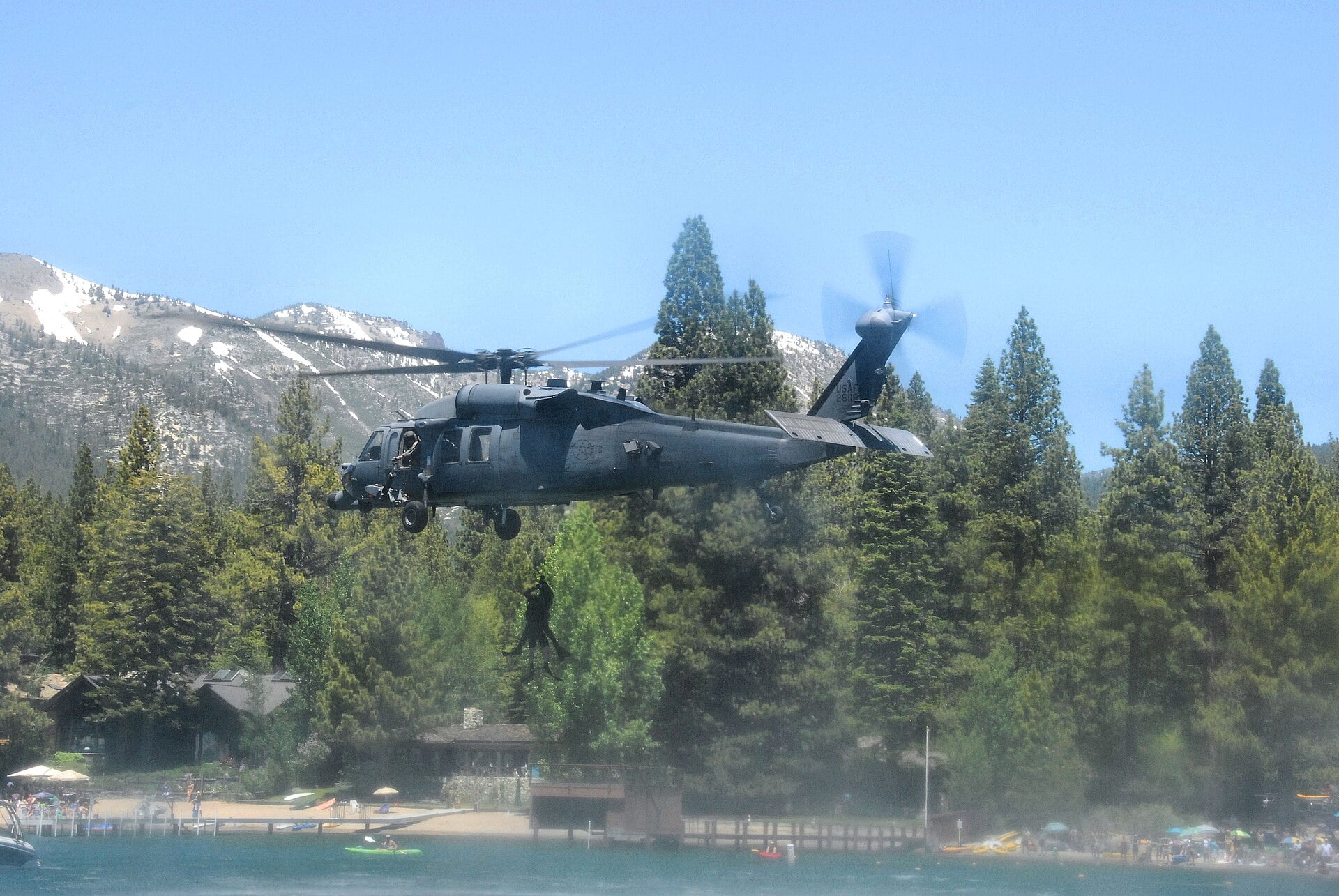 HH-60G Pave Hawk of the 129th Rescue Wing hoisting pararescuemen from Lake Tahoe