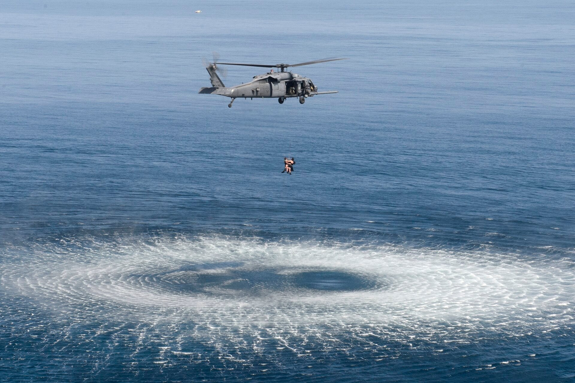 Pararescuemen hoisted into an HH-60G Pave Hawk off Djibouti