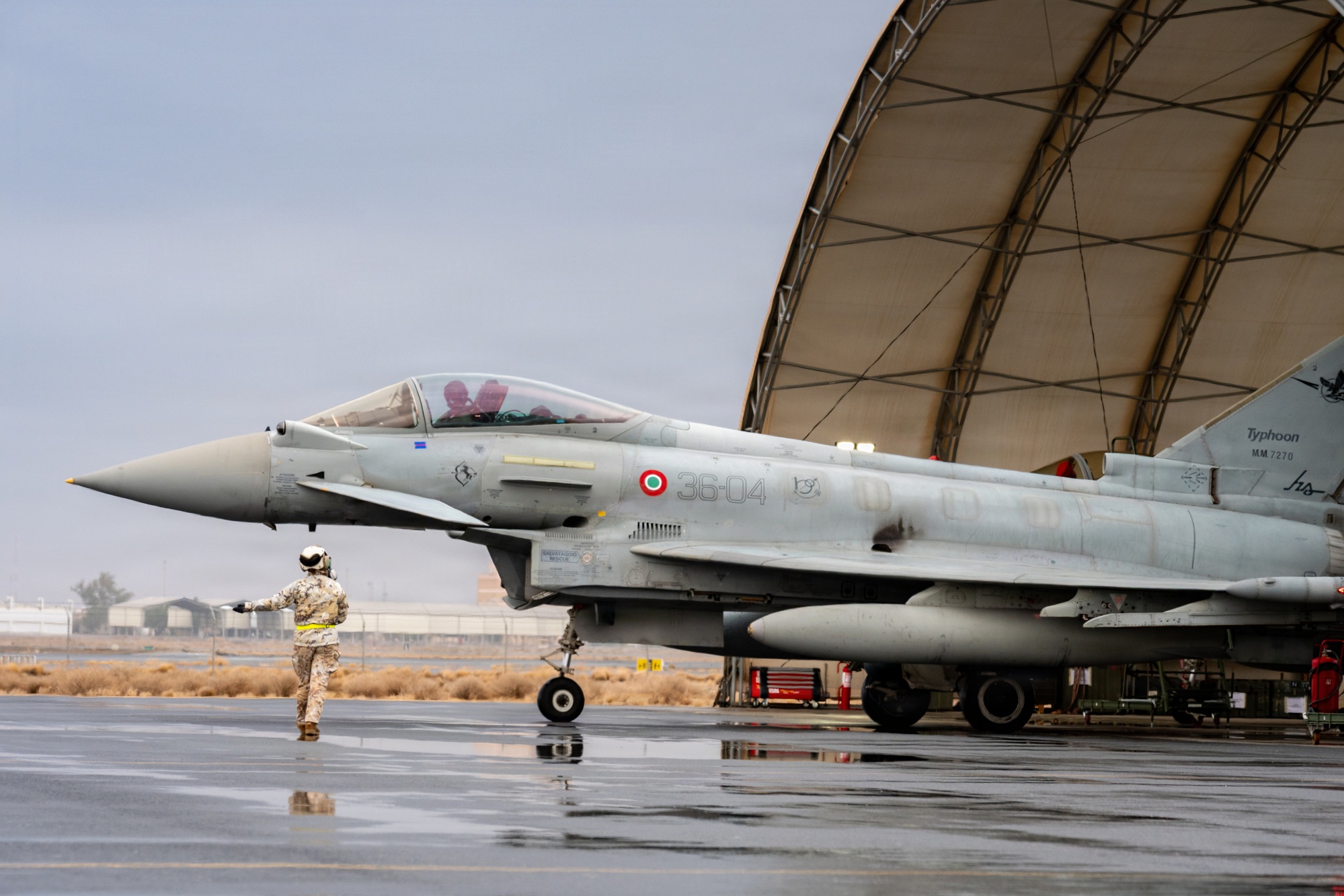 Italian Air Force Eurofighter Typhoon 36-04 parked under a sunshade on a desert ramp