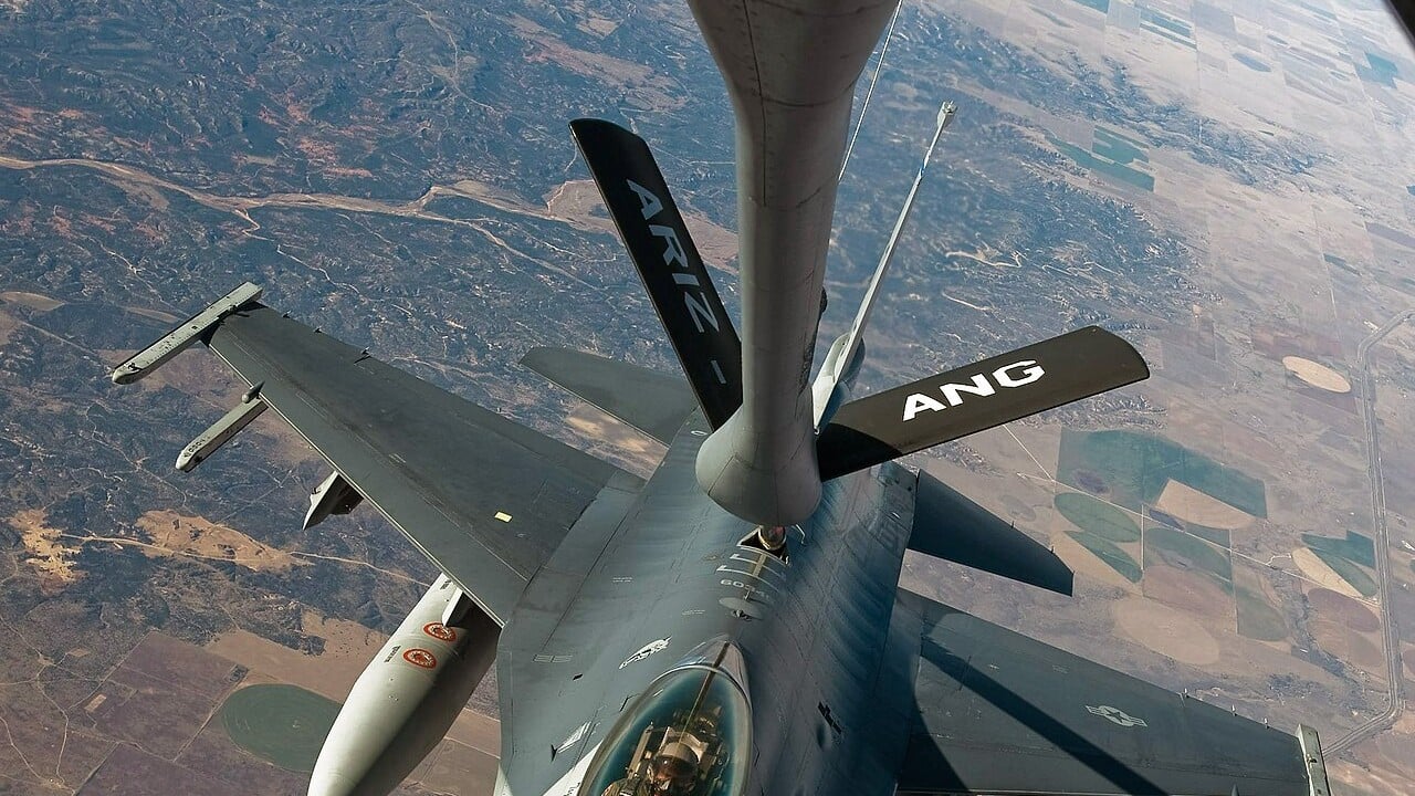 A KC-135R Stratotanker refuelling an F-16C fighter in flight