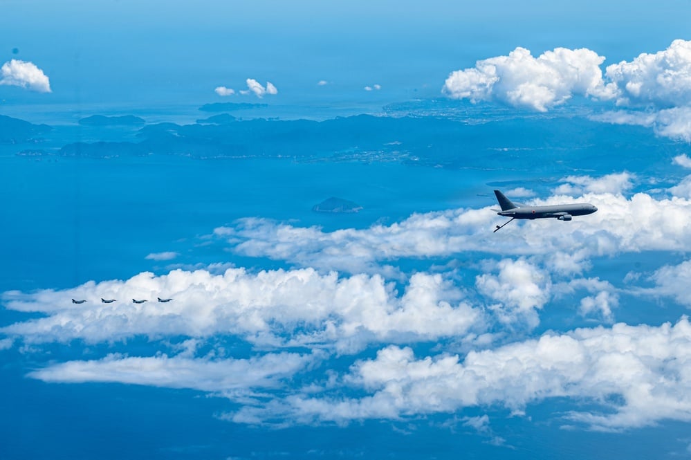 A KC-46A Pegasus in formation with Japan Air Self-Defense Force F-2 fighters