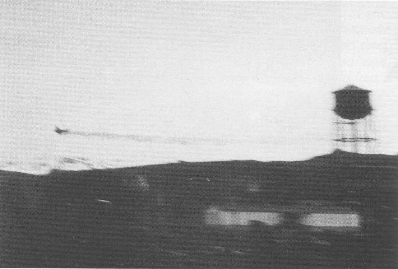 Koga Zero trailing smoke over Dutch Harbor