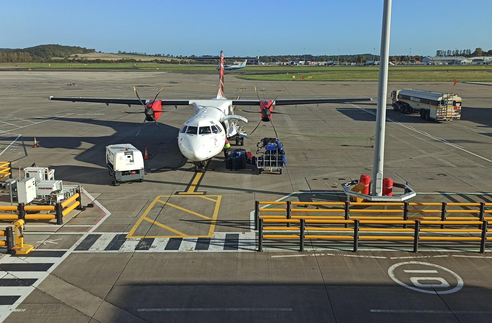 A Loganair turboprop being loaded on stand at Edinburgh Airport