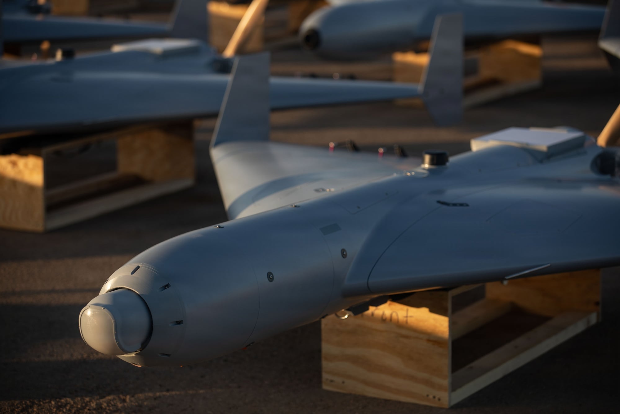 Low-cost Unmanned Combat Attack System drones positioned on the tarmac at a base in the US Central Command area