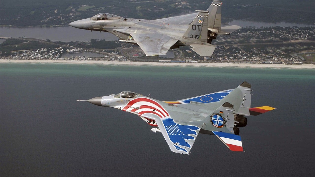 A German Luftwaffe MiG-29 flying in formation with a USAF F-15C